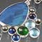 Silver, pearl, kyanite, blue topaz, chrome diopside, and opal doublet